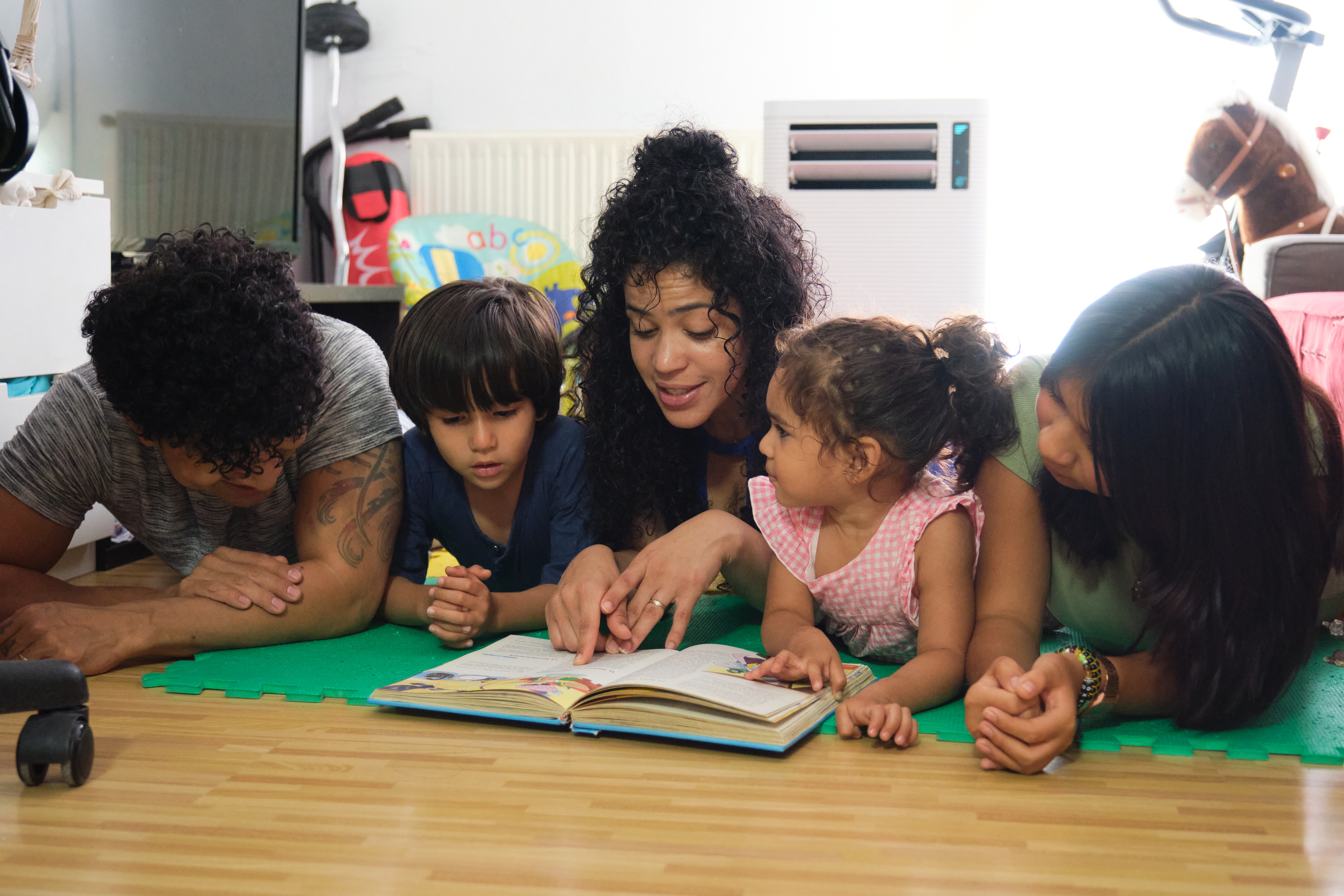 Family Reading Together on the Floor at Home