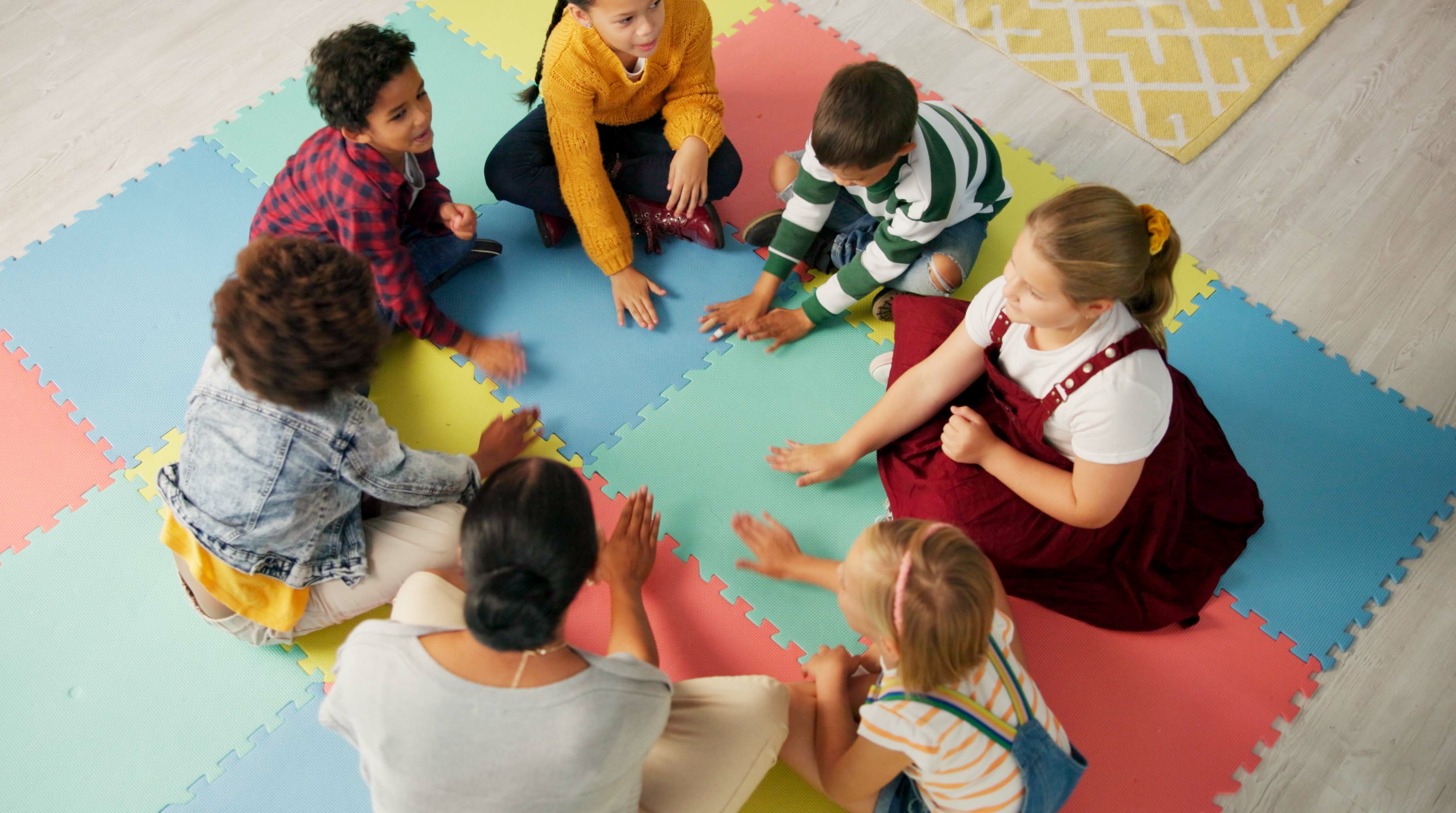 School, kids and teacher with game in circle for child development, activity and growth. High angle