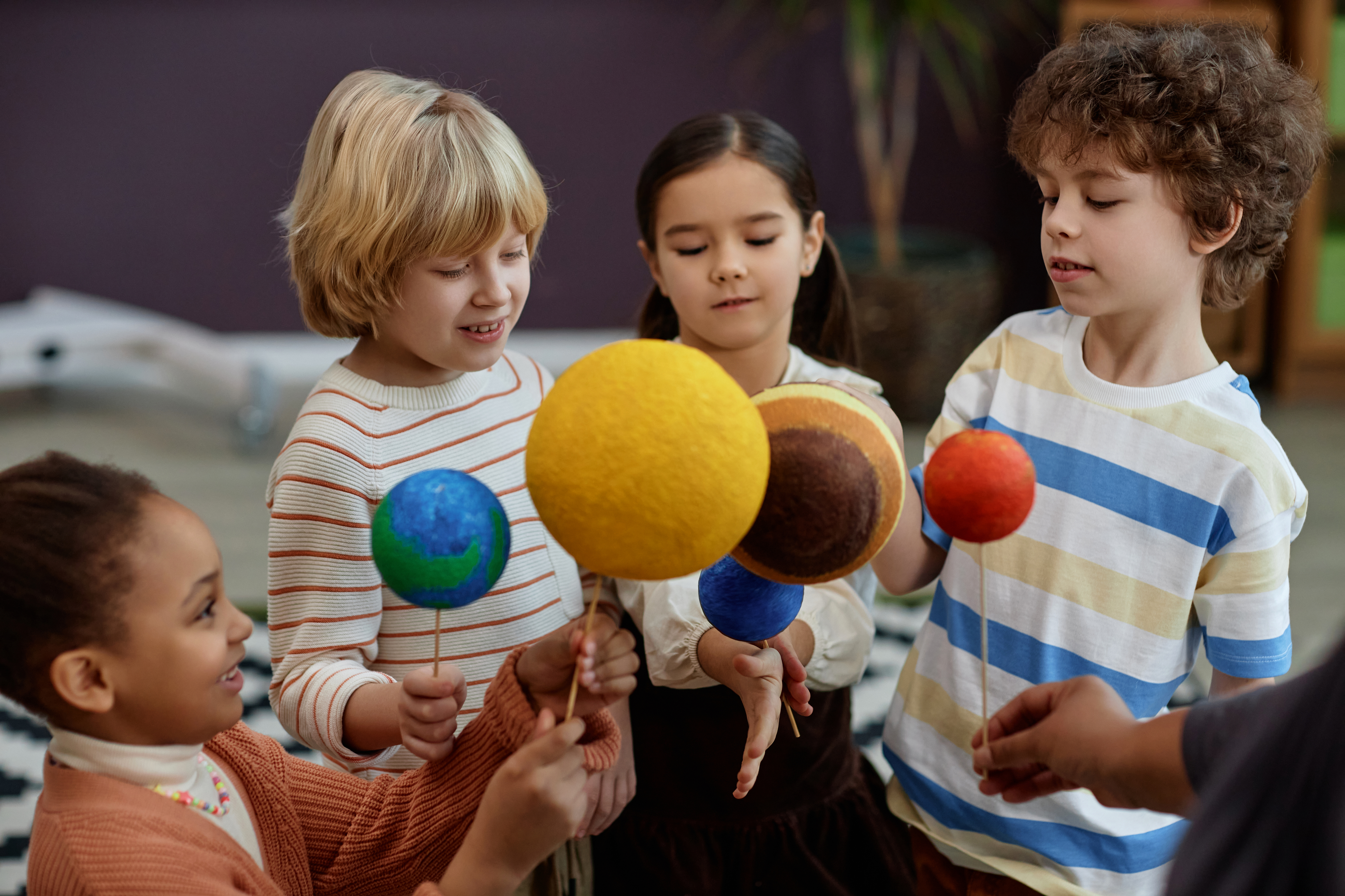 Young Children Learning About Solar System in Class